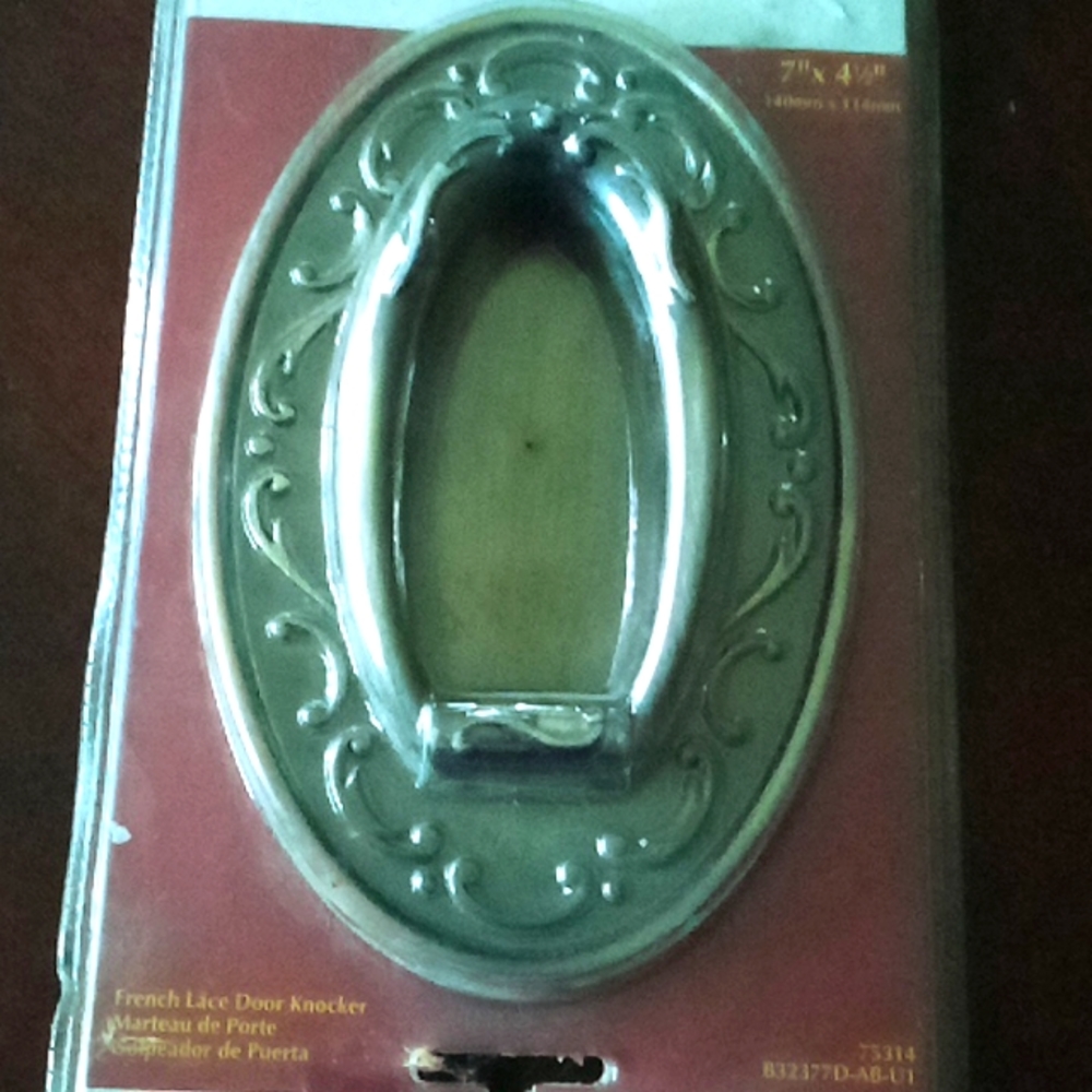 Vintage still in the package antique brass door knocker